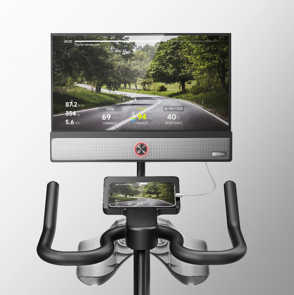 Bike simulator with screen displaying a road scene and digital metrics.