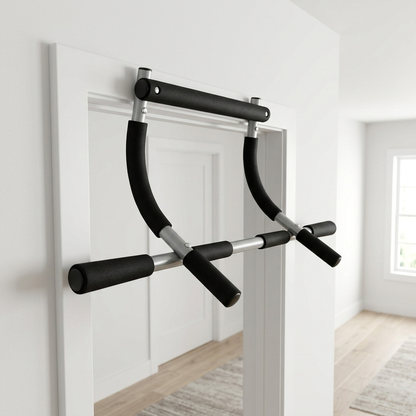 A black and silver door pull-up bar mounted on a white door frame in a bright, modern room with light wood floors.
