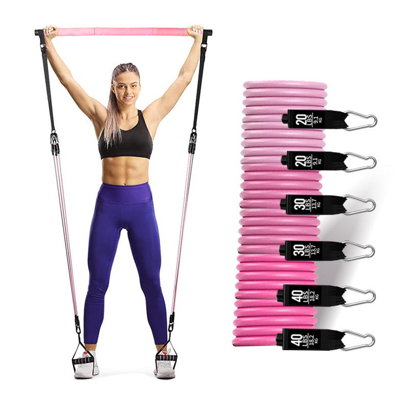 Woman exercising with resistance bands and a set of pink resistance bands on a white background