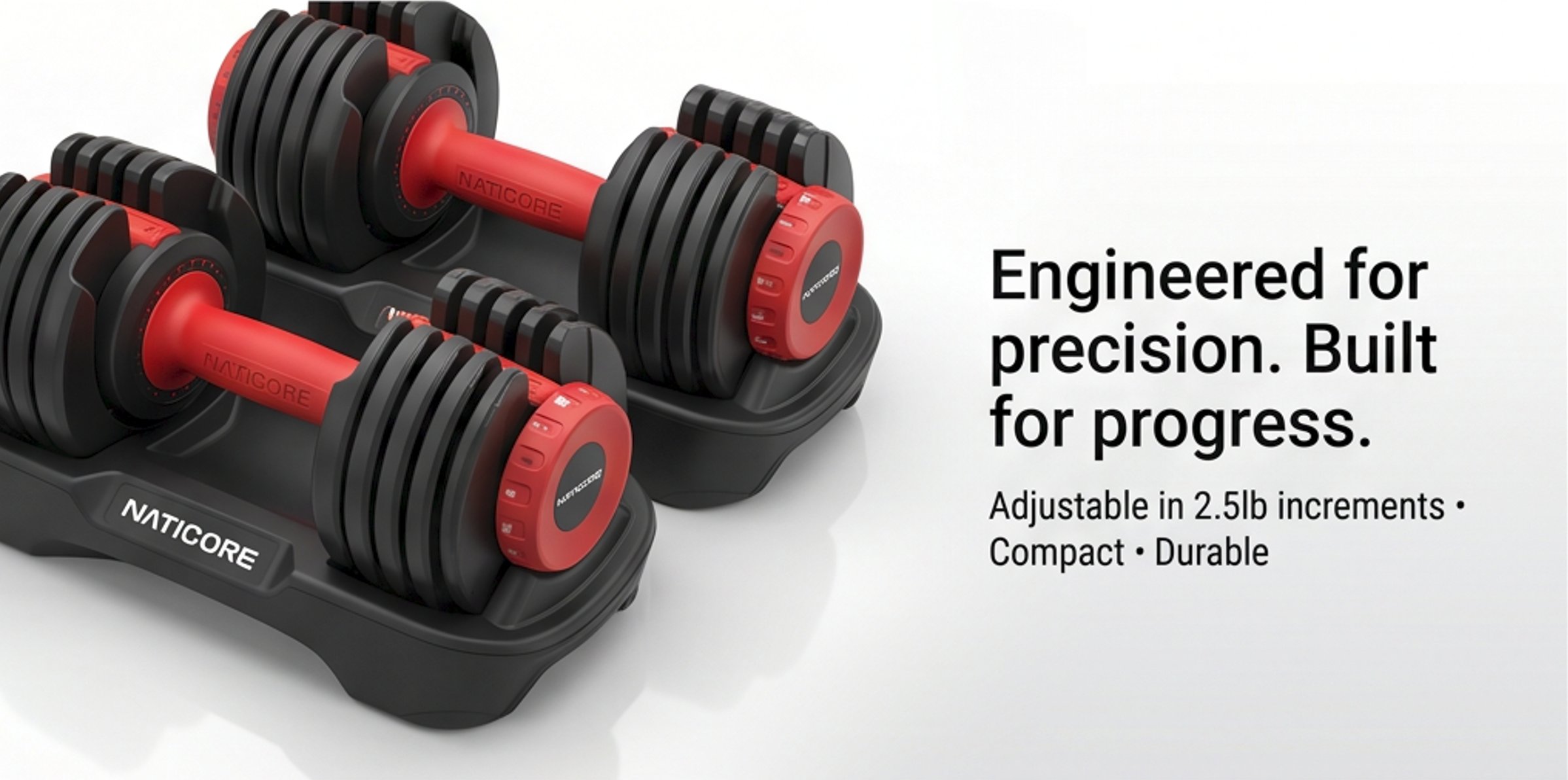 Set of adjustable dumbbells with Naticore branding on a white background